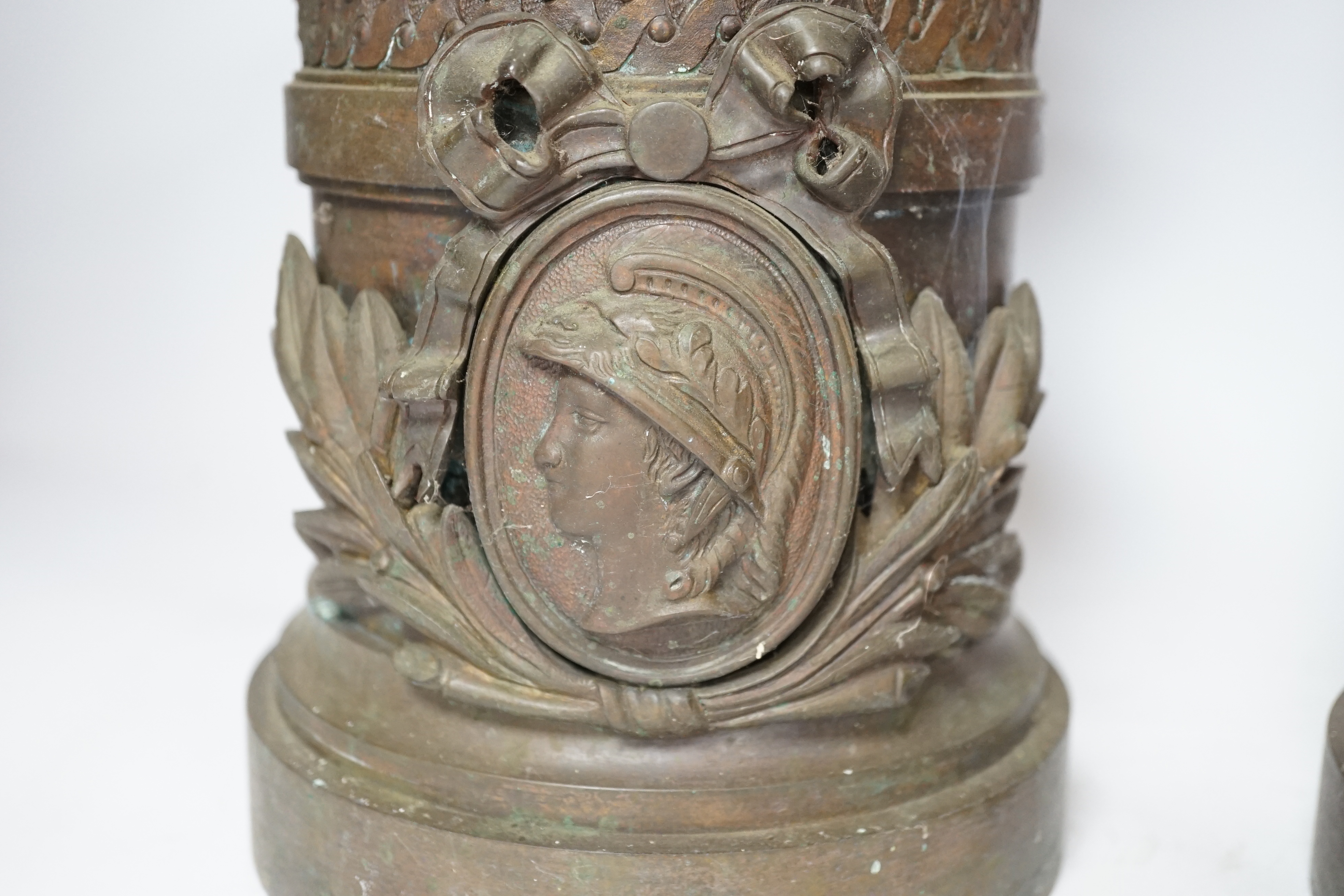 A pair of bronze urns with rams head, Roman mask and swag decoration, 53cm high